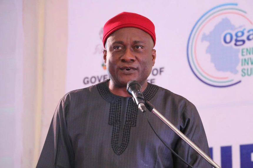 Man in red cap speaking at podium