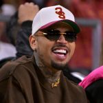 Man wearing sunglasses and cap at sports event