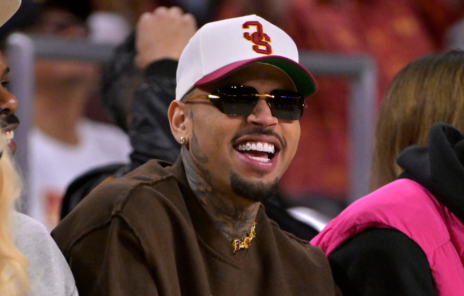 Man wearing sunglasses and cap at sports event