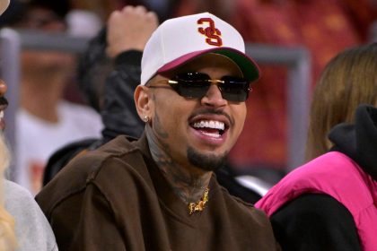Man wearing sunglasses and cap at sports event