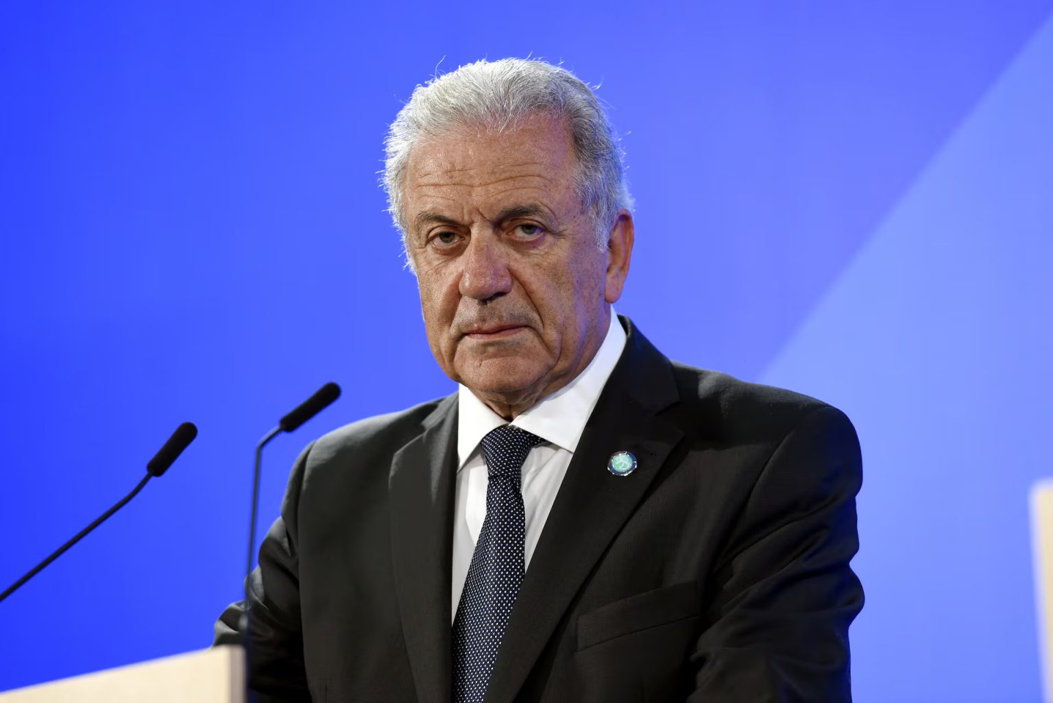 Man in suit speaking at podium