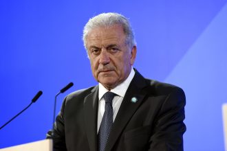 Man in suit speaking at podium