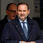 Man in suit exiting building entrance