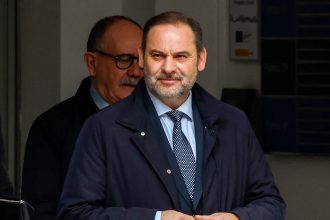 Man in suit exiting building entrance
