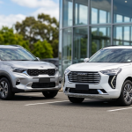 Two modern SUVs parked outside glass building