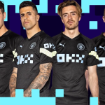 Four footballers in black Manchester City kit