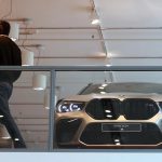 BMW X6 M in modern showroom behind glass