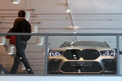 BMW X6 M in modern showroom behind glass