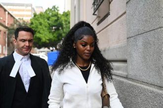 Woman walking outside courthouse with lawyer behind her