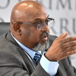 Man in suit speaking at meeting