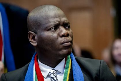 Man in suit wearing South African flag scarf