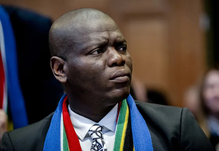 Man in suit wearing South African flag scarf