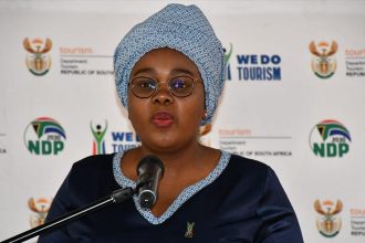 Woman speaking at tourism press briefing podium