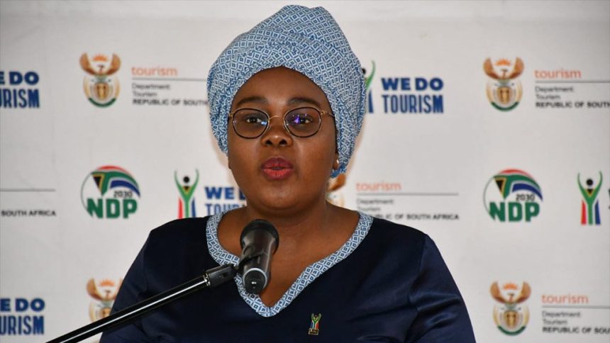 Woman speaking at tourism press briefing podium
