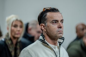 Serious man with glasses on head indoors
