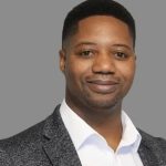 Professional man in blazer against grey background