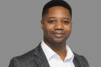 Professional man in blazer against grey background