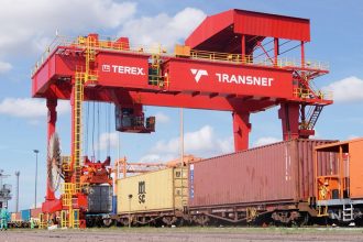 Transnet gantry crane loading containers onto freight train