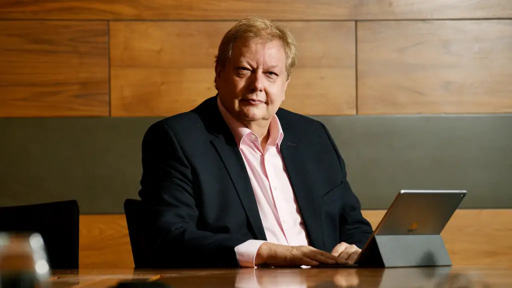 Businessman seated at table using tablet in office