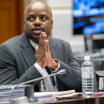 Man in suit at courtroom hearing table