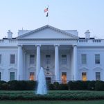 The White House featuring a central fountain and groundskeeper.