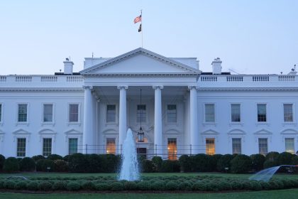 The White House featuring a central fountain and groundskeeper.