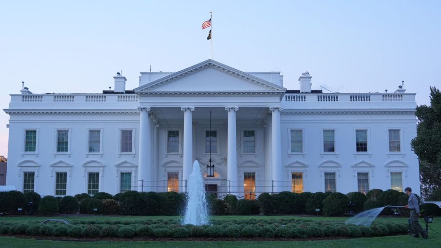 The White House featuring a central fountain and groundskeeper.