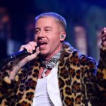 Singer performs onstage in a leopard-print coat